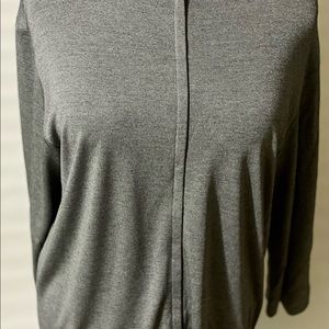 This is a Grey long sleeve sweater jacket.